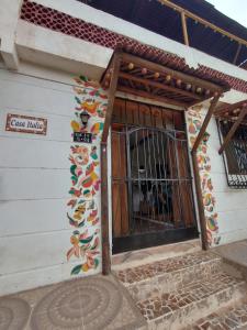 a building with a gate on the side of it at Casa Italia Guest House in Taganga