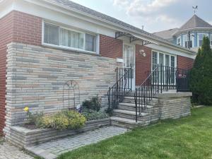 a brick house with a staircase leading to the front door at Luxurious Cozy House in Bluffs with Lake View in Toronto