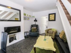 a living room with a couch and a table at Hollie Cottage in Haltwhistle