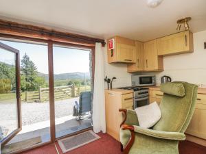 a kitchen with a view of the countryside from the window at Wren's Nest in Keswick
