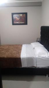 Кровать или кровати в номере HOSPEDAJE SAN GABRIEL