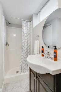 a white bathroom with a sink and a shower at Kaleidoscope Korner in Richfield