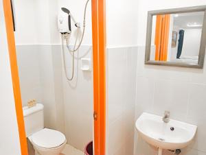 a bathroom with a shower and a toilet and a sink at Island Inn in Boracay +53 photos