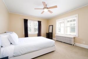 a bedroom with a white bed and a ceiling fan at Twin City Terrace in Minneapolis