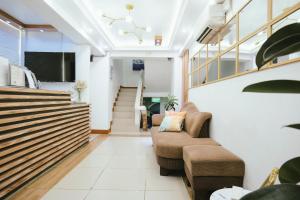 a lobby with two chairs and a staircase at Boracay Grace Hotel in Boracay