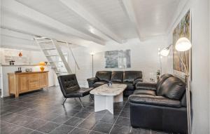 a living room with a couch and a table and chairs at Stunning Apartment In Rm With 2 Bedrooms And Wifi in Rømø Kirkeby