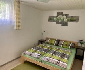 ein Schlafzimmer mit einem Bett und einem Tisch mit einer Lampe in der Unterkunft Ferienwohnung Haus am Bach in Toggenburg in Wildhaus