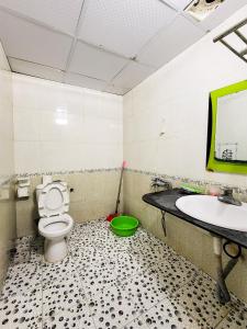a bathroom with a toilet and a sink at Nhật Anh Hotel Cát Bà in Cat Ba