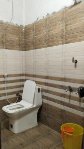 a bathroom with a white toilet in a room at Funky Art Beach House in Alleppey