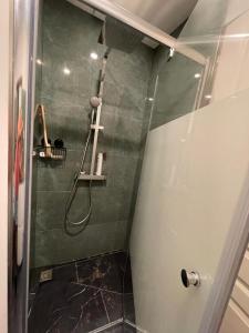 a shower with a glass door in a bathroom at chambre cosy privée chez Franck in Bordeaux