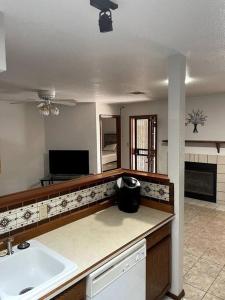 a kitchen with a sink and a counter top at Townhouse, two car garage, fireplace back yard in Las Cruces