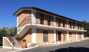 a large brick building with a balcony on it at B&b Mula Germaneto in Santa Maria