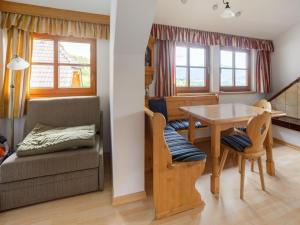 een woonkamer met een tafel en een stoel bij Holiday apartment in Mariapfarr near ski area in Mariapfarr