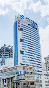 a tall building with a sign on top of it at Ha Luo Hotel in Kunming