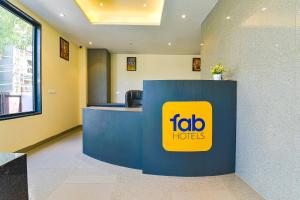 an office with a blue and yellow sign on a counter at FabHotel Prime Pink City Park in Jaipur