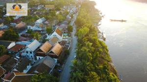 an aerial view of a village next to the water at Mekong Charm Riverside in Luang Prabang