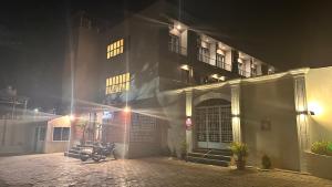 um edifício com motocicletas estacionadas em frente a ele à noite em Hotel Unnati em Aurangabad