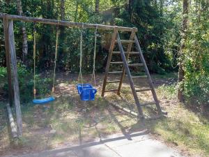 an old swing set with two blue buckets on it at 5 person holiday home in H jslev in Sundstrup