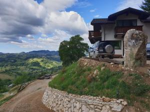 a car parked in front of a house on a hill at Chalet Betleem in Măgura