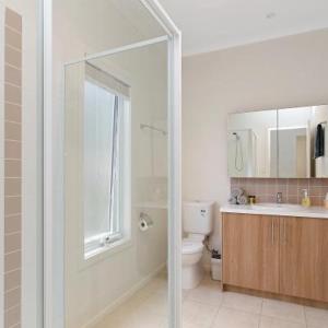 a bathroom with a shower and a toilet and a sink at Anlyn seaside cabin in Apollo Bay