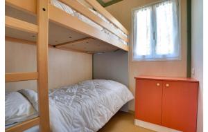 a bedroom with a bunk bed and a window at 3 Bedroom Nice Home In La Faute-Sur-Mer in La Faute-sur-Mer +34 photos