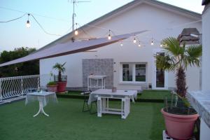 a white patio with a table and a tent at Terrazza Zalamella Bed and Breakfast in Ravenna