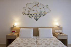 a bedroom with a bed with a heart on the wall at Hippocampus Hotel in Kamari