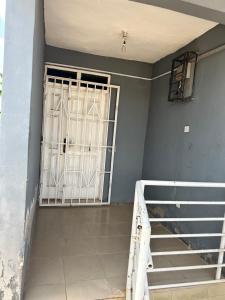 un cancello in una stanza con scala e porta di Chila Apartment a Accra
