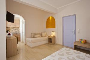 a small living room with a bed and a kitchen at Hippocampus Hotel in Kamari
