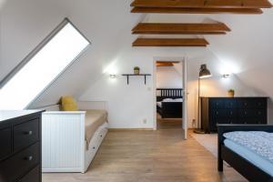 a attic bedroom with a bed and a staircase at FARMAOBECKOV sk in Obeckov