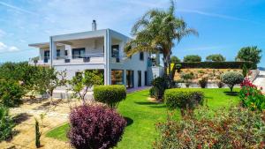 A garden outside Mythic Olive villa - Heated Pool - Amazing view