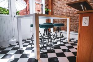 a bar with stools on a checkered floor at Historic Charm in Victoria BC's Waddington Alley in Victoria
