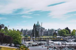 a city with a marina and a large building at Historic Charm in Victoria BC's Waddington Alley in Victoria