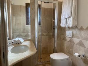 a bathroom with a shower and a sink and a toilet at La casa degli Ibiscus in Porto Ottiolu +16 photos