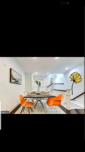 a dining room with orange chairs and a table at Waterfront mansion in Baltimore