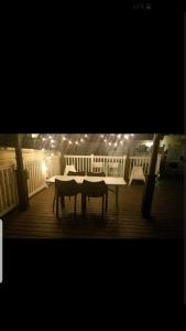 a table and chairs on a deck with lights at Waterfront mansion in Baltimore