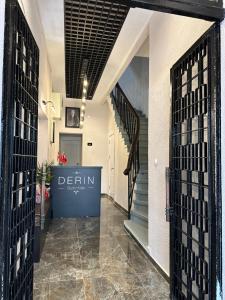 a hallway with a door with a sign that reads derin at DERİN BUTİK HOTEL in Tekirdag