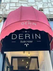 a pink awning over the entrance to a derin derum building at DERİN BUTİK HOTEL in Tekirdağ