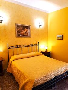 フォンディにあるBed And Breakfast Camere Primaveraのベッドルーム1室(黄色い壁のベッド1台付)