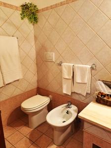 a bathroom with a toilet and a sink with towels at Bed And Breakfast Camere Primavera in Fondi +47 photos