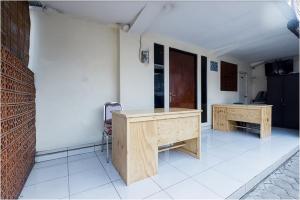 a room with two wooden desks in a room at Hotel Cemara Gading in Bubulak 3