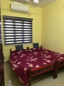 a bedroom with a large bed in a room with a window at Gods own home stay in Cochin