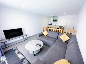 a living room with a couch and a table at Brylin Motel in Rotorua