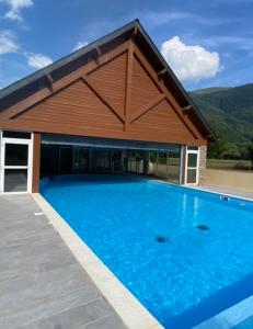 a large swimming pool with a large building at Appartement Les Pics d'Aran in Luchon