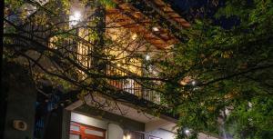 a building with a balcony with lights on it at Kandy Tree Tops in Kandy