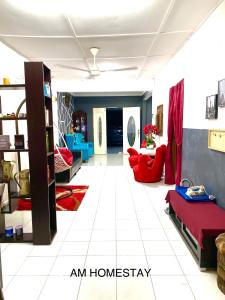 a living room with blue and red furniture at Am Homestay Rembau in Rembau