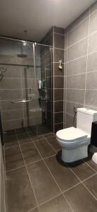 a bathroom with a toilet and a shower at H&W Sunway Onsen Suites Services Tambun Ipoh S-07-05 in Ipoh