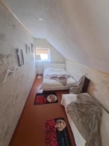 a room with two beds and posters on the floor at Imantas in Salacgrīva