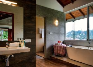 - deux images d'une salle de bains avec baignoire et lavabo dans l'établissement Kandy Tree Tops, à Kandy