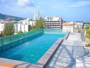 a swimming pool on the roof of a building at Cocoon APK Resort & Spa in Patong Beach